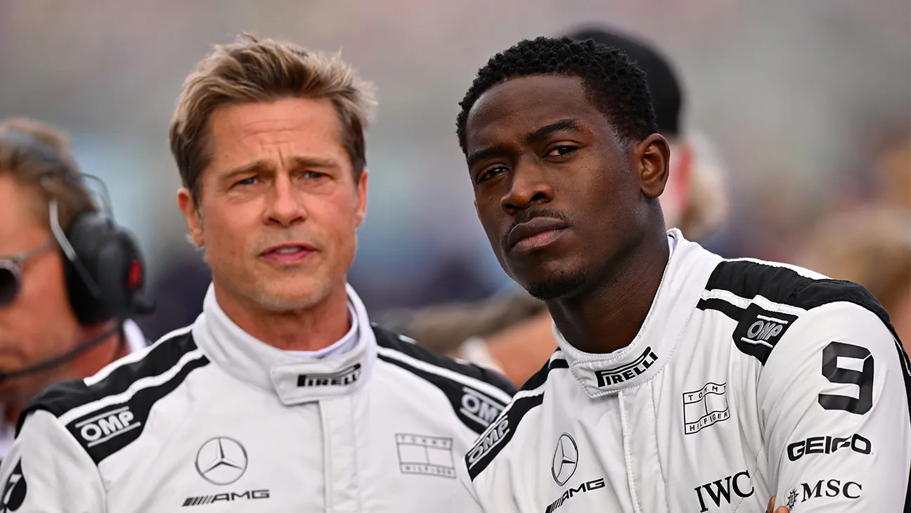 Two racing drivers in white suits from the movie F1
