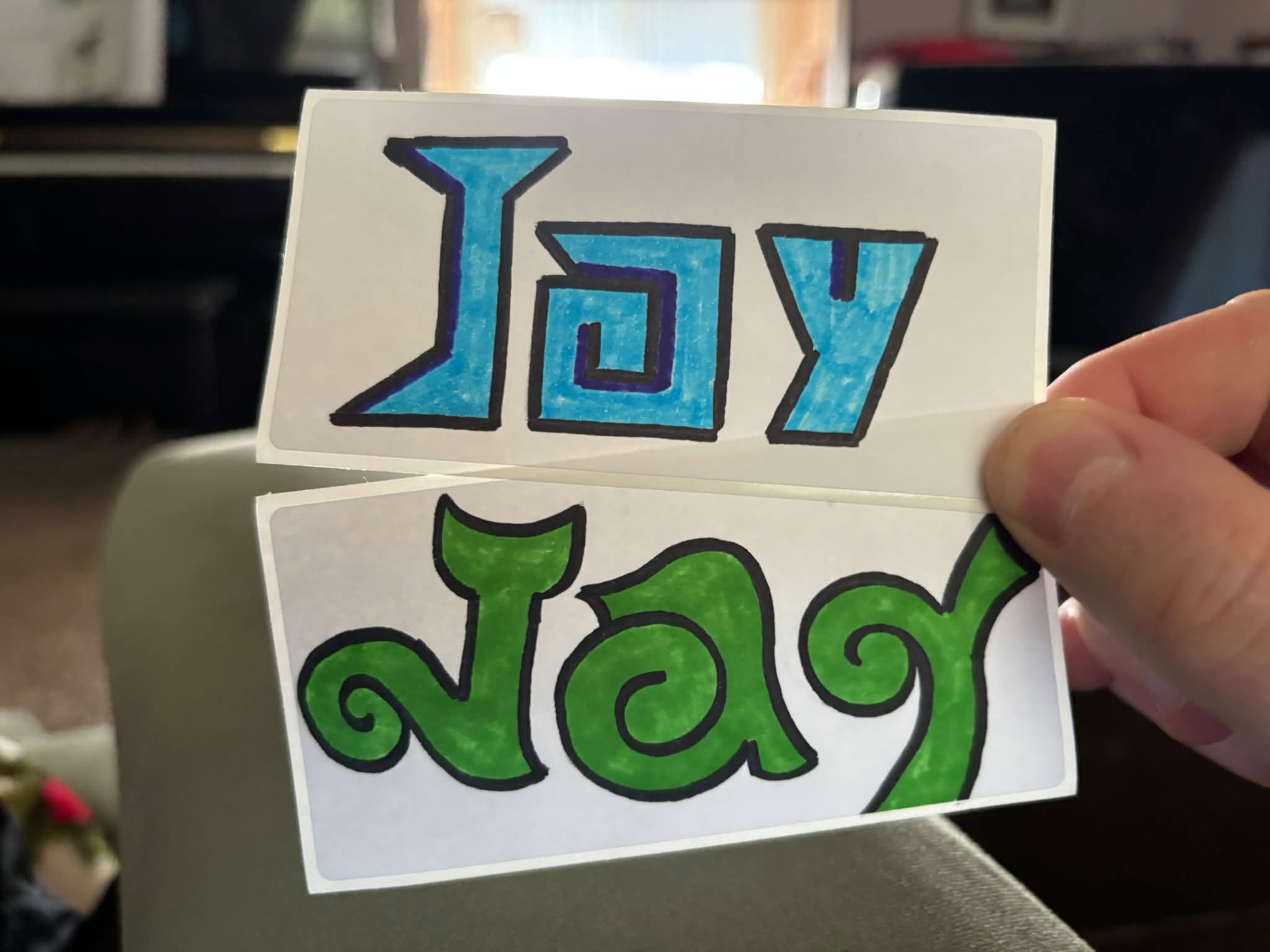 Two handmade name tags designed by Jay Archambeau's son